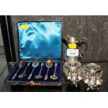 A silver cream jug, a cased set of gilded coffee spoons, a pair of silver salts and a silver