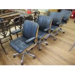 A set of four Gordon Russell leather adjustable office chairs, with oak ply backs, leatherette