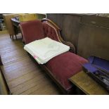 A mid Victorian mahogany chaise longue, the scroll carved back and arm on turned tapering legs and