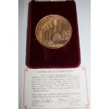 A cased bronze medallion certifying the 100th anniversary of the Metropolitan Opera House