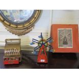 A German tinplate clockwork chair-o-planes ferris wheel in original box and a Cowan de Groot child's
