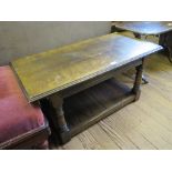 An oak coffee table, in 18th century style, the rectangular top on turned and block supports with