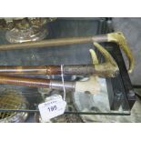 A Swaine and Adney horn and leather riding crop with silver collar; a Swaine and Co horn and