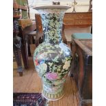 A pair of large famille noire vases of baluster form depicting exotic birds within bamboo and