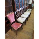 A pair of early Victorian rosewood dining chairs with c-scroll carved backs and moulded cabriole