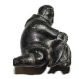A Inuit stone carving of a figure
