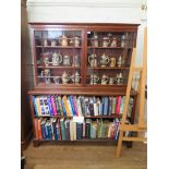 A mahogany bookcase, the top section with two glazed doors over open shelves on bracket feet,