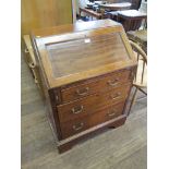 An Edwardian mahogany and satinwood crossbanded bureau, the panelled slope over three graduated