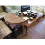 A reproduction crossbanded mahogany coffee table, the rectangular top on moulded square legs,