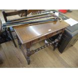 A 17th century style oak side table, the rectangular top over a panelled frieze drawer on bobbin