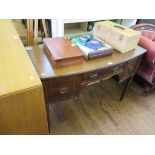 An Edwardian mahogany bowfront dressing table, the central drawer and kneehole flanked by deep