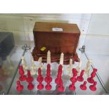 A late 19th century turned ivory chess set, in original box, with narrow form king and queen