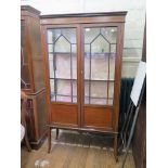 An Edwardian mahogany display cabinet, with chequer and boxwood banding, the glazed panelled doors