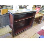 A mahogany open bookcase, with blind fret carved frieze and supports on square tapering legs,