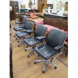 A set of four Gordon Russell leather adjustable office chairs, with oak play backs, leatherette