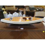 A timber scale model of a luxury speed boat, mounted on a stand, 62cm long