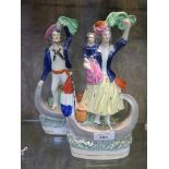 A pair of Victorian Staffordshire figures of a Sailor and his wife with child, both standing in