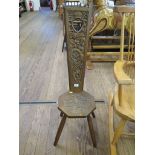 An Edwardian carved ash Welsh spinning stool, the long tapering back with pierced heart motif carved