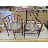 An Edwardian stained wood open armchair with spindle back, upholstered seat and turned tapering