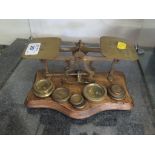 A set of brass postal scales with weights