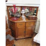 A late Victorian mahogany corner side cabinet, the raised back with bevelled mirrors over dummy