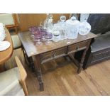 An oak side table in the 17th century style with two panelled frieze drawers on ring turned legs,