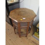 An Indian brass and copper inlaid octagonal occasional table, with fret carved panel sides, 51cm