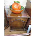 An oak cabinet in the George III style, with arched panel door and bracket feet, 56cm wide