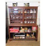 A mahogany bookcase, the top section with two glazed doors over open shelves on bracket feet,