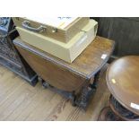 An oak gateleg table, the oval top on barley-twist legs, stretchers and turned feet, 71cm wide