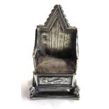 A silver pin cushion in the form of the coronation chair