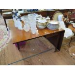 A George III style mahogany drop leaf table, the rectangular top over chamfered legs with brass