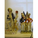 A Victorian Staffordshire figure of Napoleon III and Prince Albert shaking hands, with flags behind,