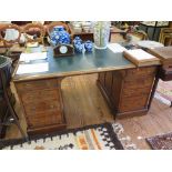 An early 20th century mahogany pedestal desk, the leather inset top over two pedestals each with