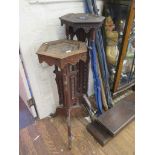 Two Indian carved wood jardinere stands with hexagonal tops and tripod bases with pendants and