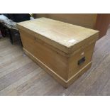 A pine chest, of rectangular form with hinged lid and metal handles, 93cm wide