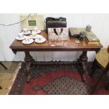 A Victorian mahogany sofa table, the rectangular top with pendant corners on turned columns and pole