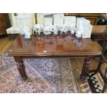 An early Victorian mahogany extending dining table, the rectangular moulded top with extra leaf on