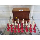 A late 19th century turned ivory chess set, in original box, with narrow form king and queen