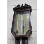 A GEORGE III MAHOGANY STICK BAROMETER with break arch pediment, the stem with boxwood and ebony