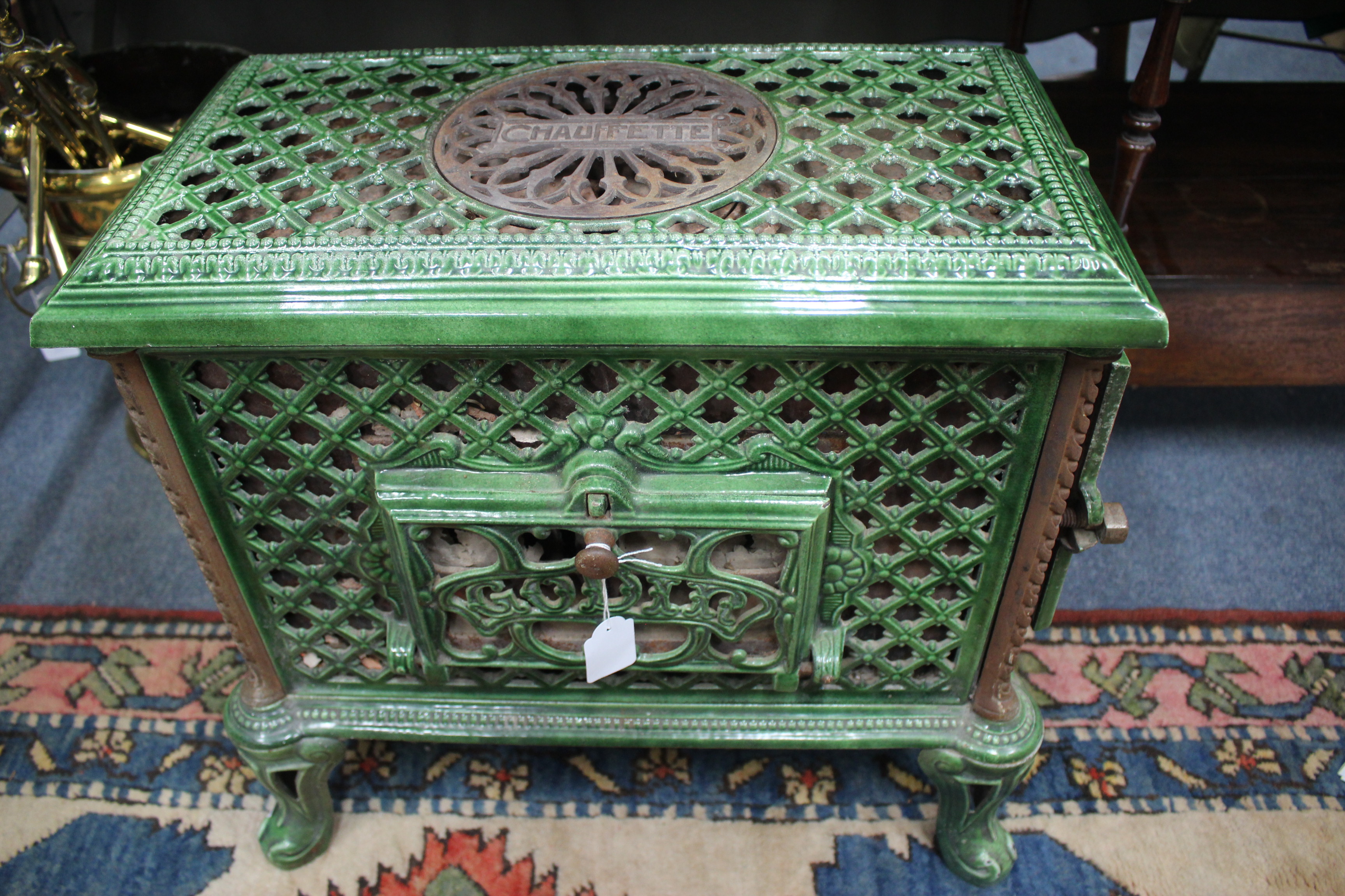 A 1920'S FRENCH GREEN ENAMELLED CHAUFFETTE WOOD BURNING STOVE by Godin and with pierced lattice work