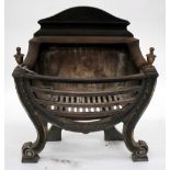 A GEORGIAN STYLE CAST IRON FIRE GRATE with turned urn finials, bowed front and scrolling feet, 56.