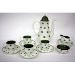 A SUSIE COOPER BONE CHINA ONE O'CLOCKS PATTERN COFFEE SERVICE to include four cups, six saucers,