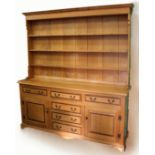 A GEORGE III STYLE LIGHT OAK DRESSER, the upper section with a cavetto moulded cornice above three