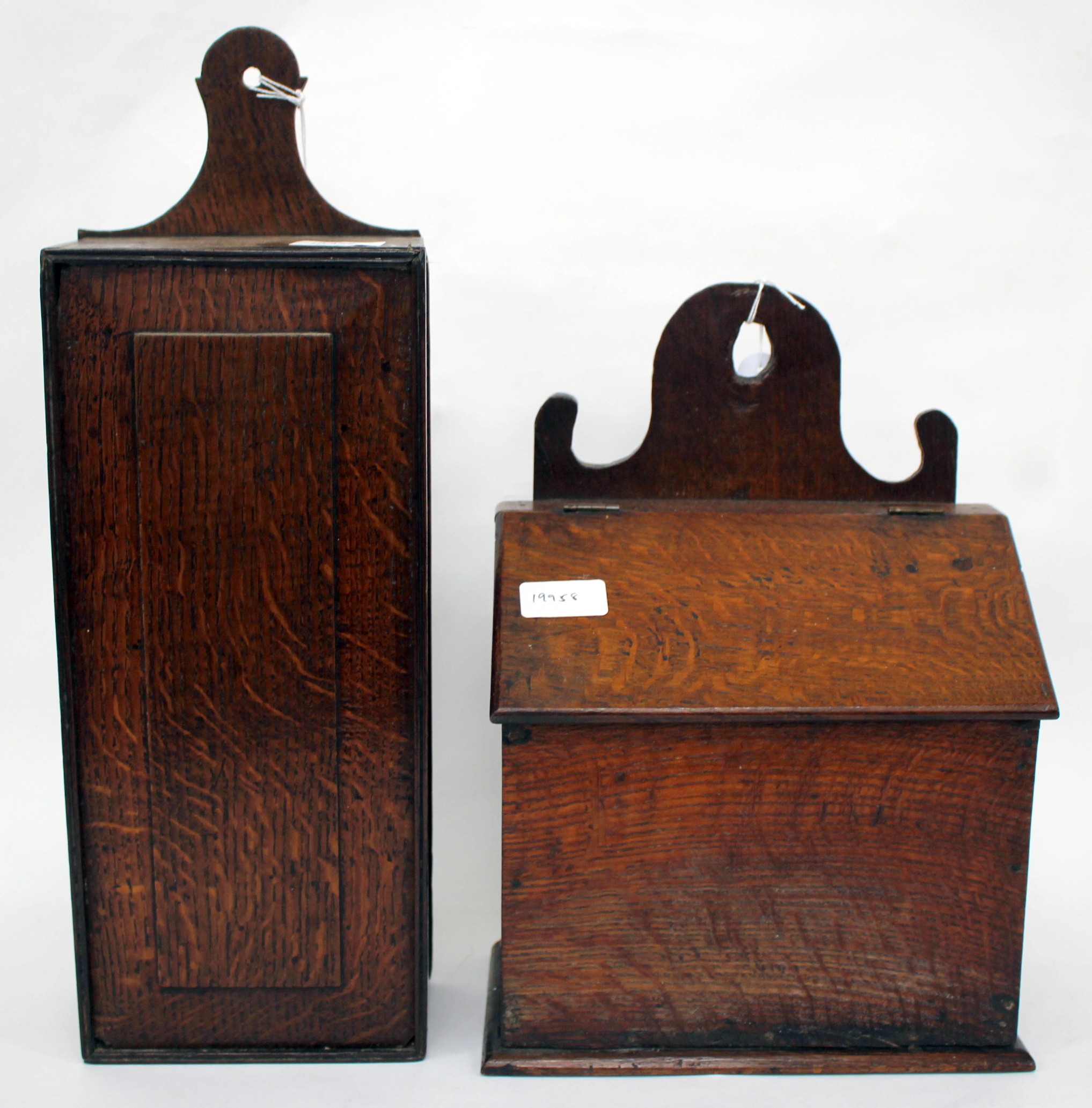 AN ANTIQUE OAK CANDLE BOX with a fret carved back and a sloping lid 24cm wide together with a 19th