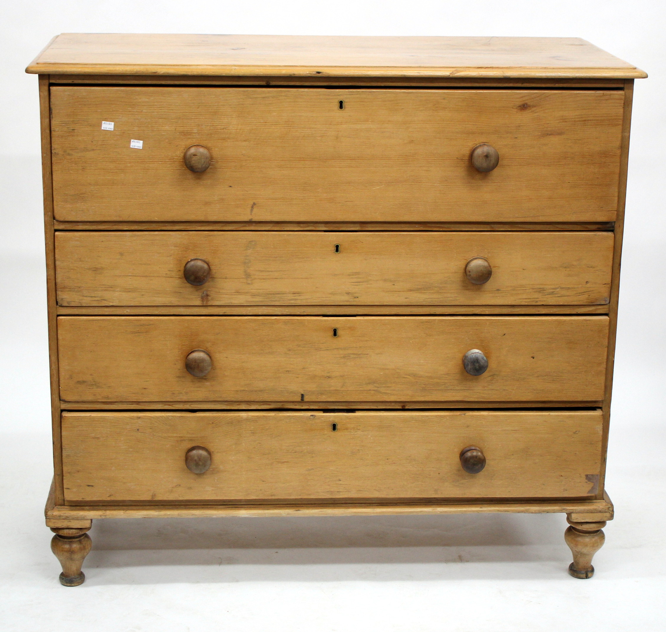 A LARGE VICTORIAN PINE CHEST OF FOUR LONG DRAWERS with turned knob handles and turned feet, 125cm