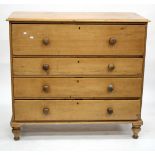 A LARGE VICTORIAN PINE CHEST OF FOUR LONG DRAWERS with turned knob handles and turned feet, 125cm