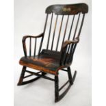 A 19TH CENTURY PAINTED ROCKING CHAIR with a spindle back 58cm wide