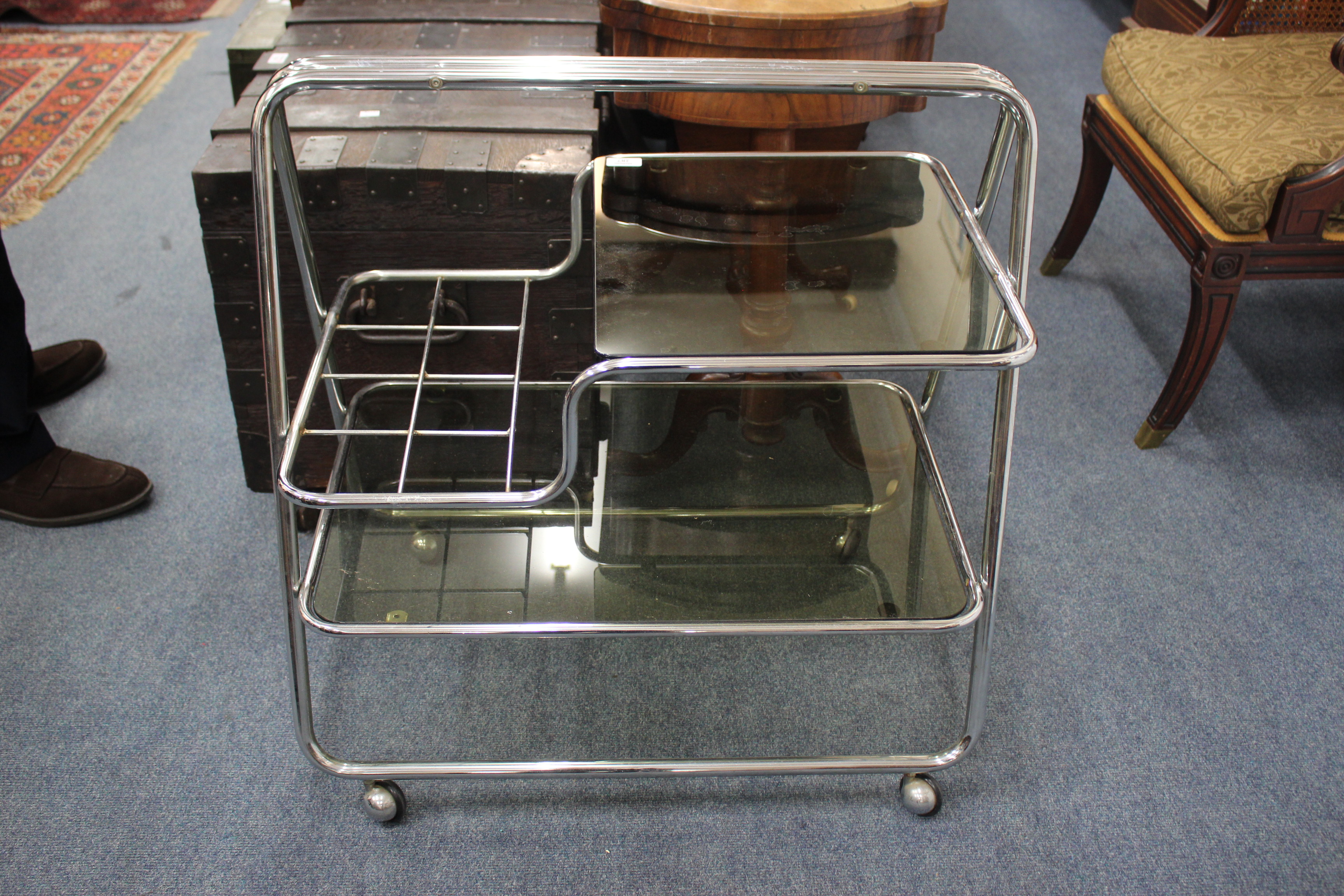 A VINTAGE CHROME AND GLASS TEA TROLLEY 72cm wide