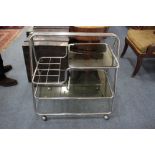 A VINTAGE CHROME AND GLASS TEA TROLLEY 72cm wide